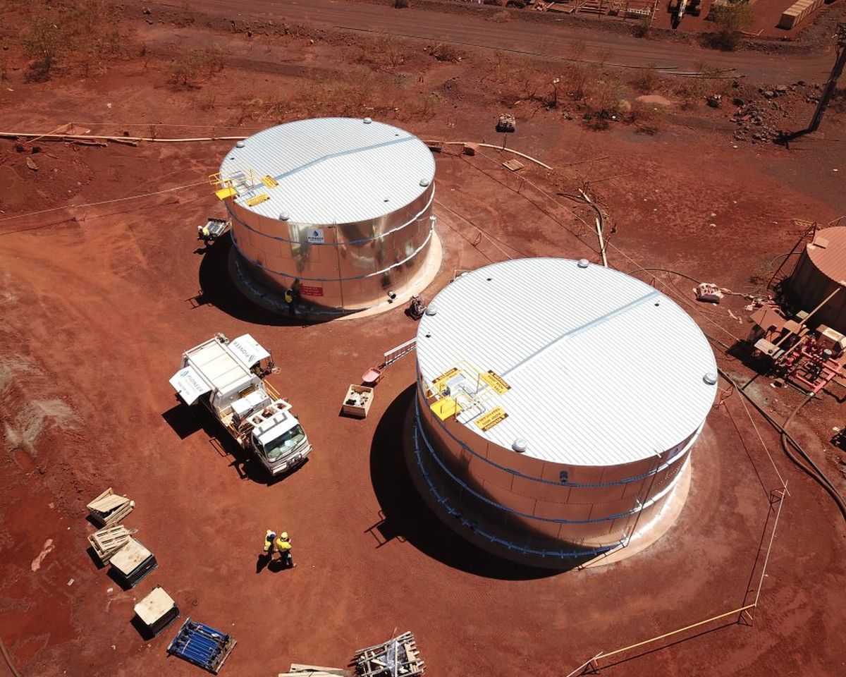 Two Pioneer tanks installed on a red-dirt regional site, seen from above
