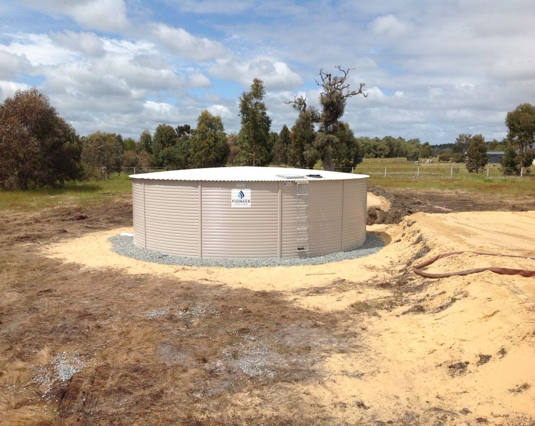 Newly installed Pioneer water tank on a sand pad in a rural paddock